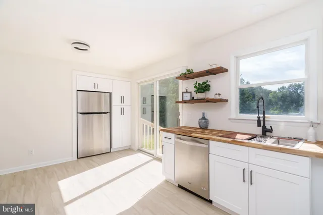 a kitchen with a sink and refrigerator