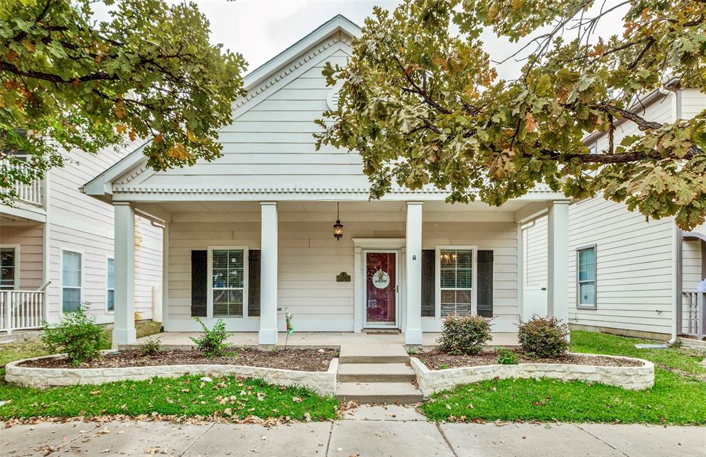 a front view of a house with garden and plants