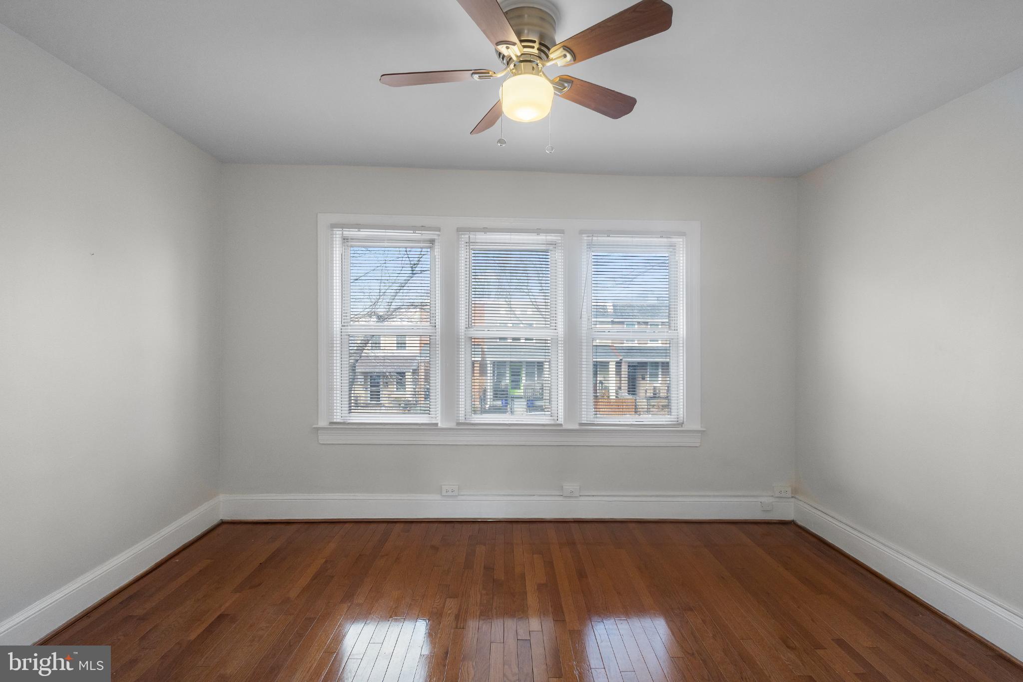 1841 L Street Northeast Washington, DC 20002 - Photo 11 of 31 a view of an empty room with wooden floor and a window