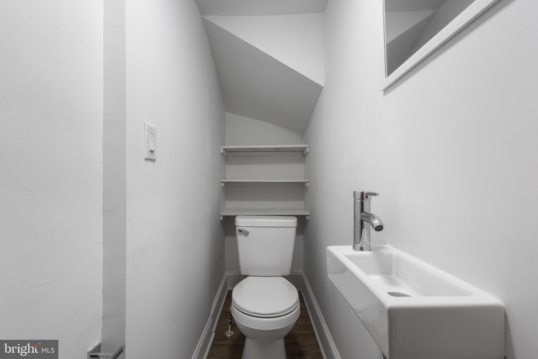 1841 L Street Northeast Washington, DC 20002 - Photo 17 of 31 a white toilet sitting next to a bathroom sink