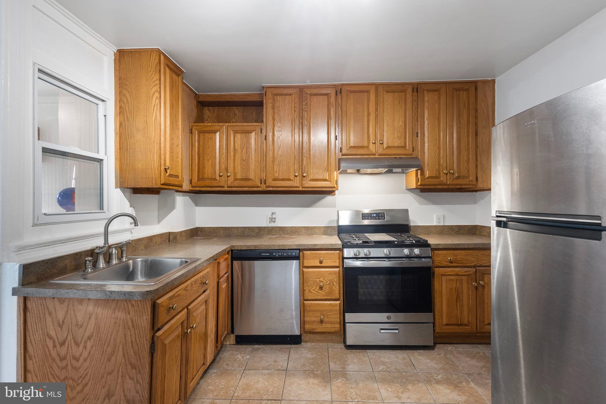 1841 L Street Northeast Washington, DC 20002 - Photo 19 of 31 a kitchen with a stove sink and refrigerator
