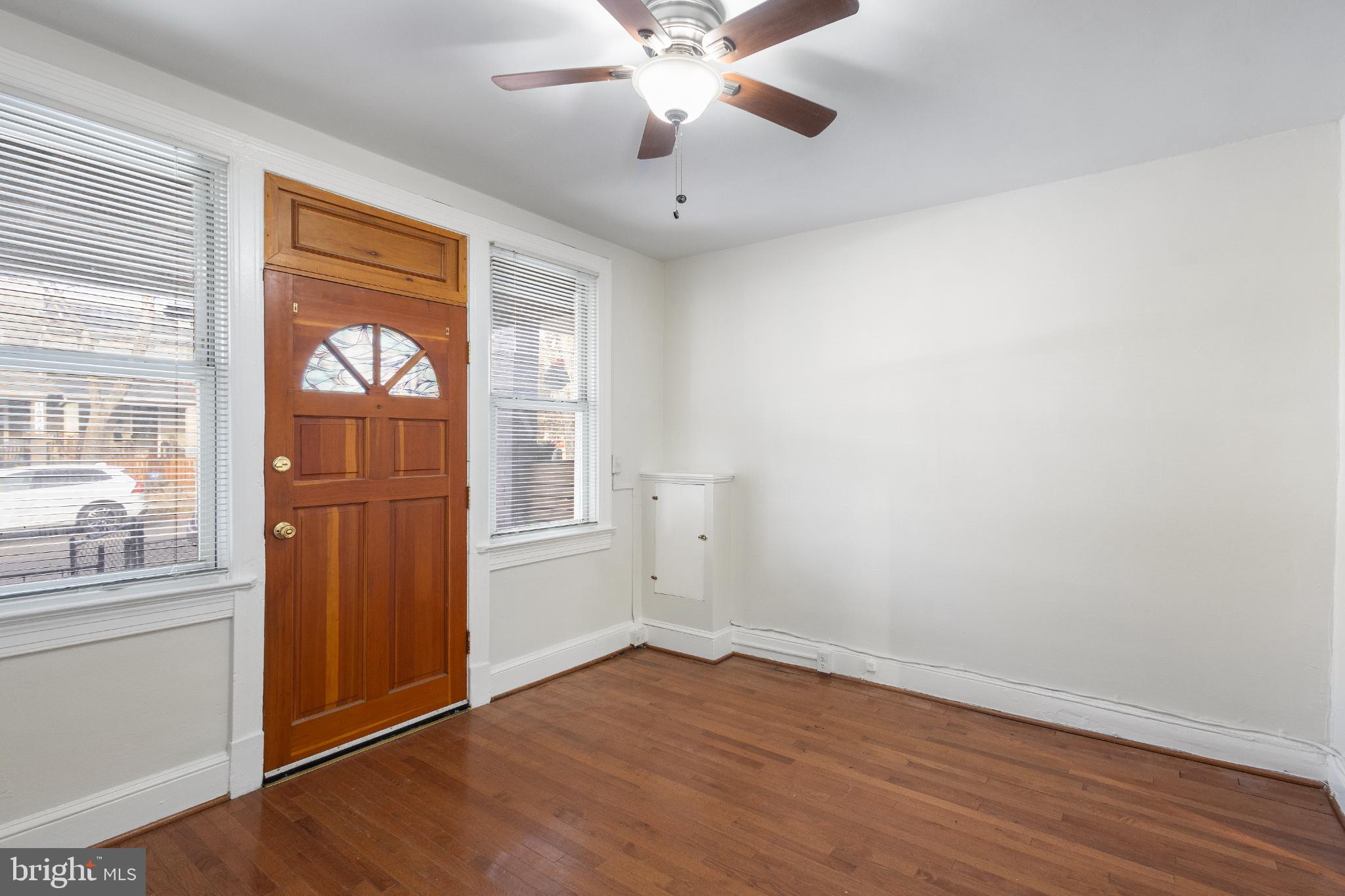 1841 L Street Northeast Washington, DC 20002 - Photo 4 of 31 wooden floor in an empty room with a window