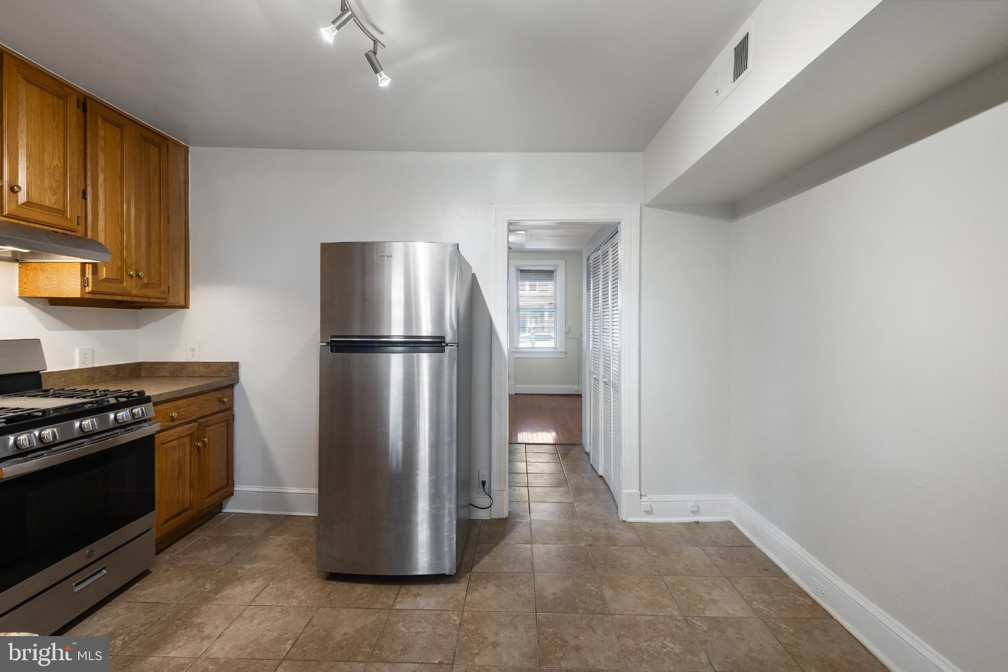 1841 L Street Northeast Washington, DC 20002 - Photo 8 of 31 a kitchen with a refrigerator stove and cabinets