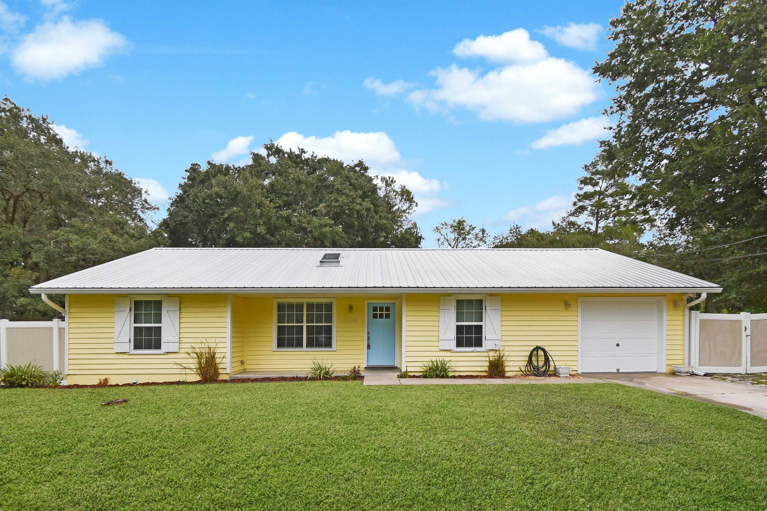 1196 Brookside Court St. Augustine, FL 32086 - Photo 1 of 29 a front view of a house with a garden