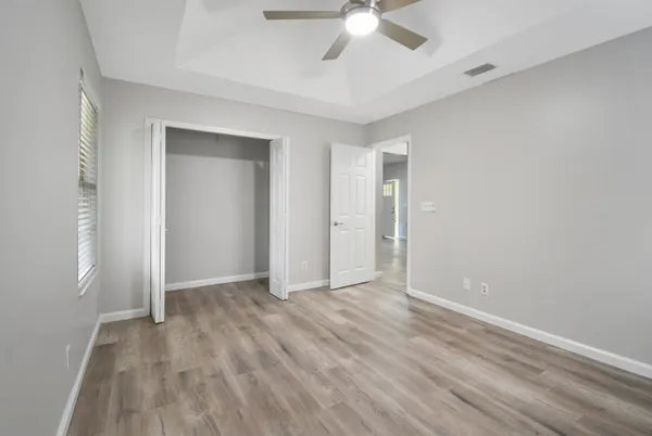 a view of an empty room with wooden floor