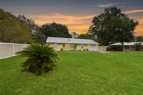 a front view of house with yard and green space