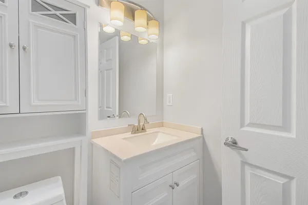 a bathroom with a sink vanity and a mirror