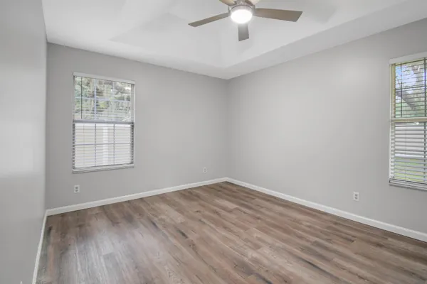 wooden floor in an empty room with a window