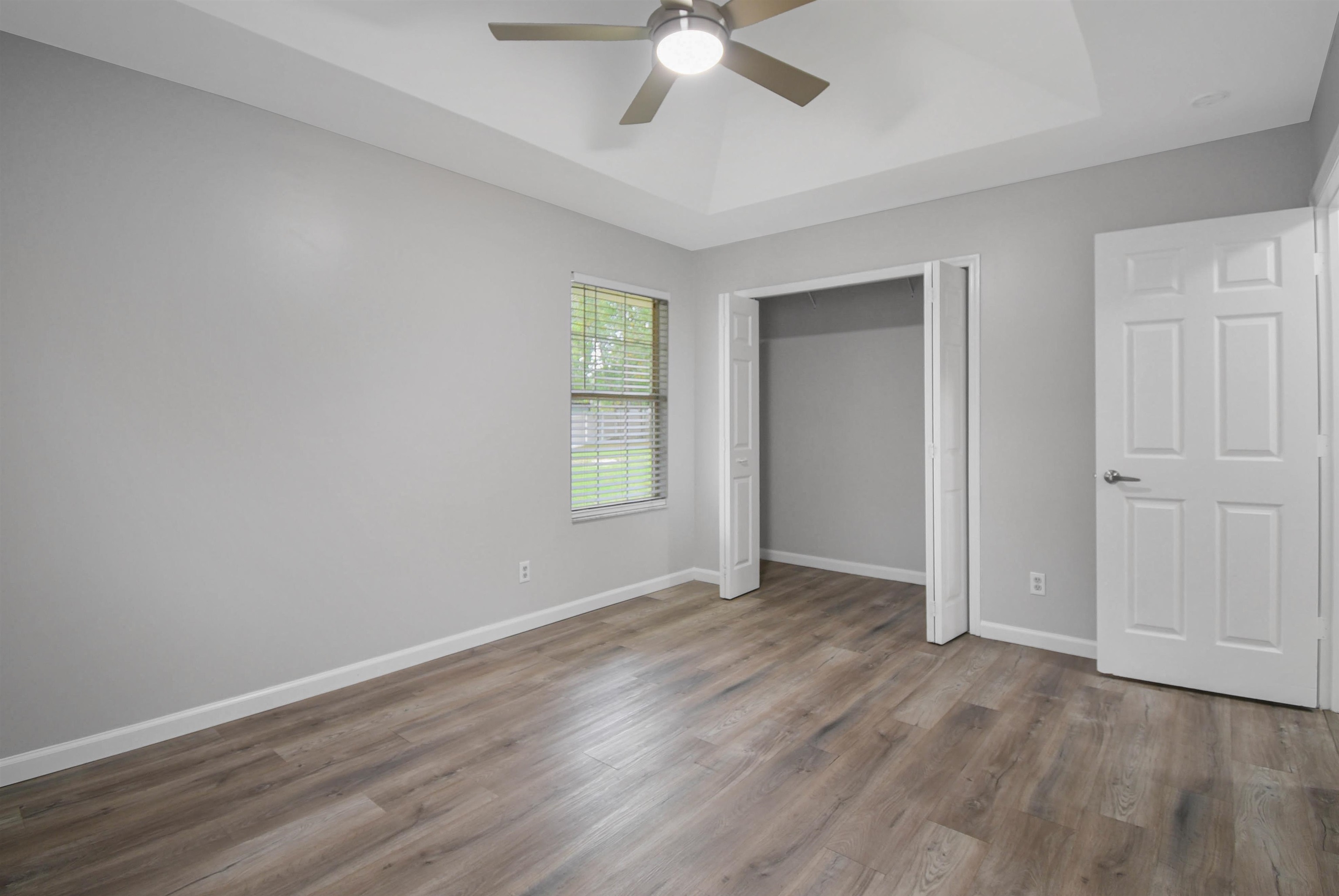1196 Brookside Court St. Augustine, FL 32086 - Photo 24 of 29 an empty room with wooden floor ceiling fan and windows