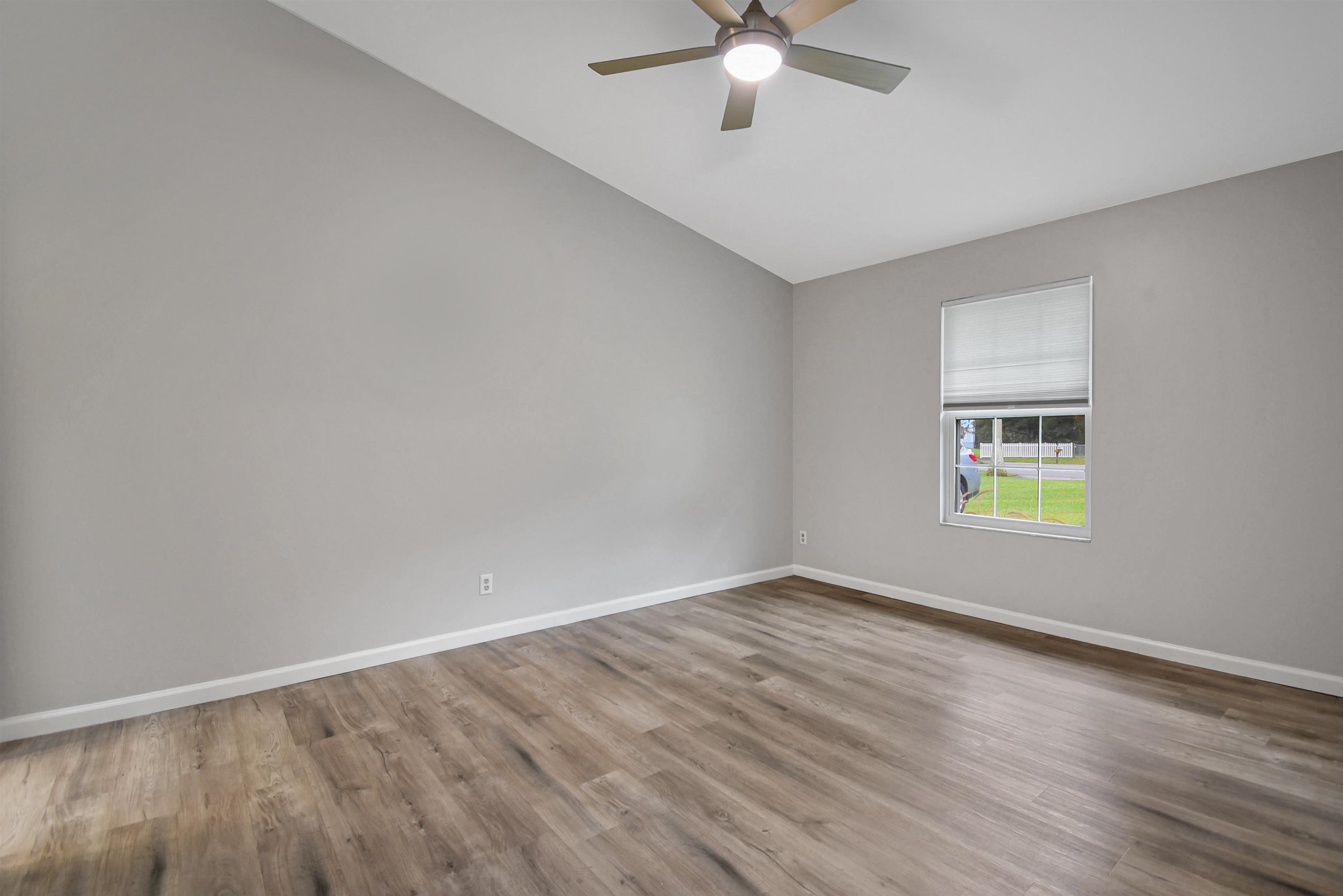 1196 Brookside Court St. Augustine, FL 32086 - Photo 26 of 29 a view of an empty room with wooden floor and a window