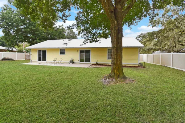 a front view of house with yard and green space