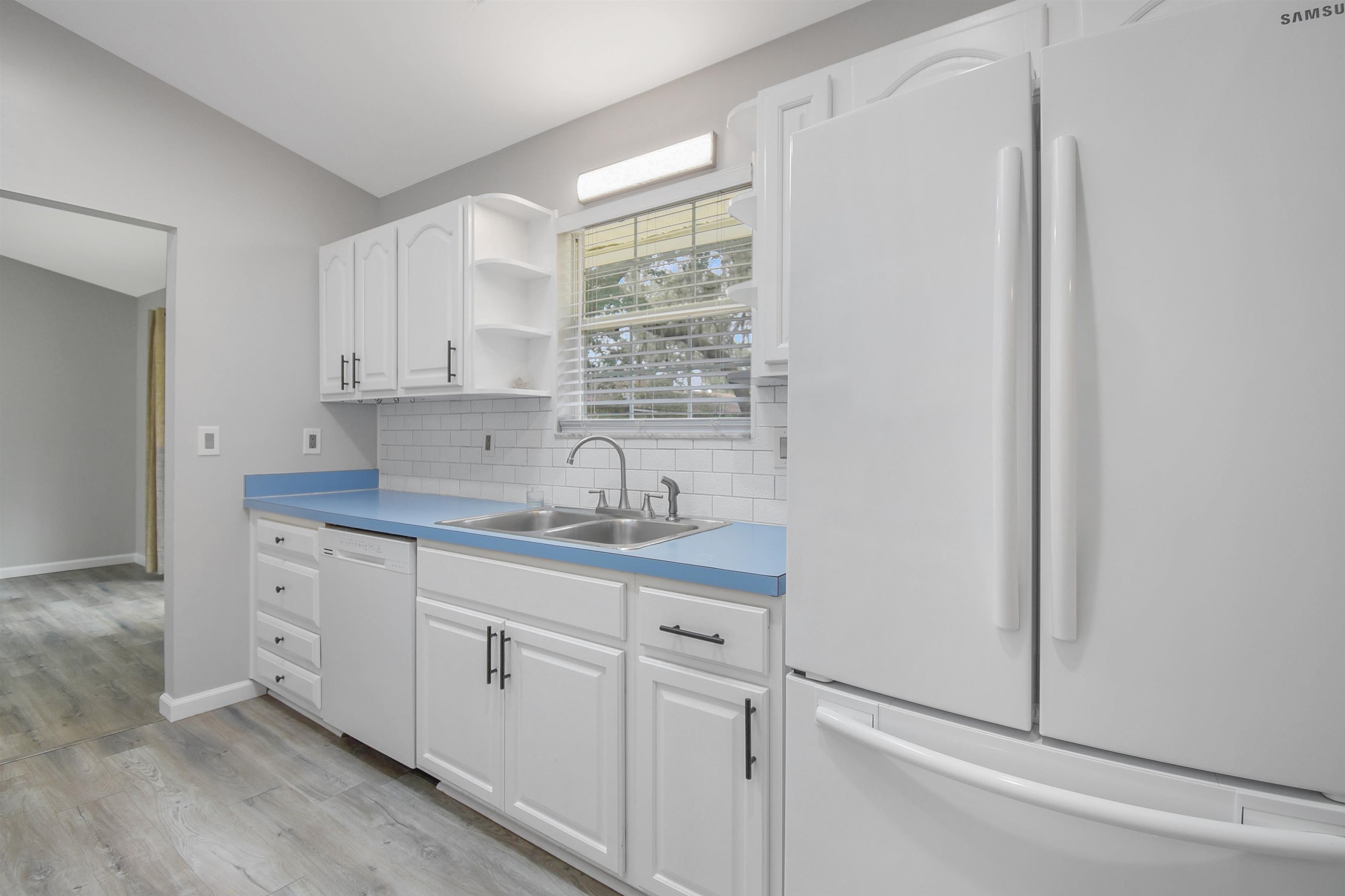 1196 Brookside Court St. Augustine, FL 32086 - Photo 8 of 29 a kitchen with white cabinets and white appliances