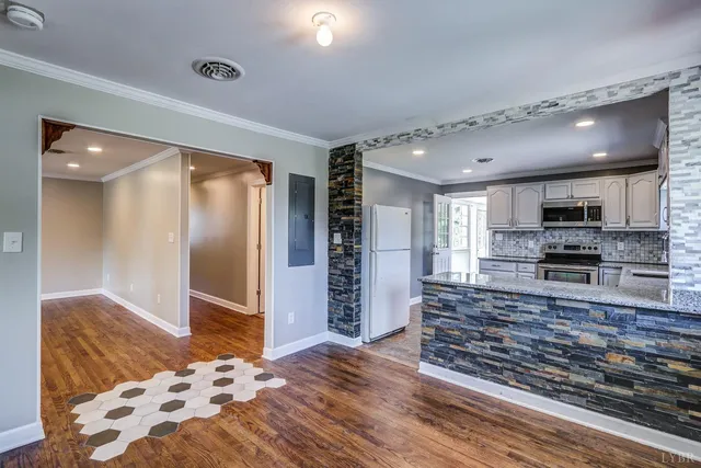 a large kitchen with cabinets and outdoor space