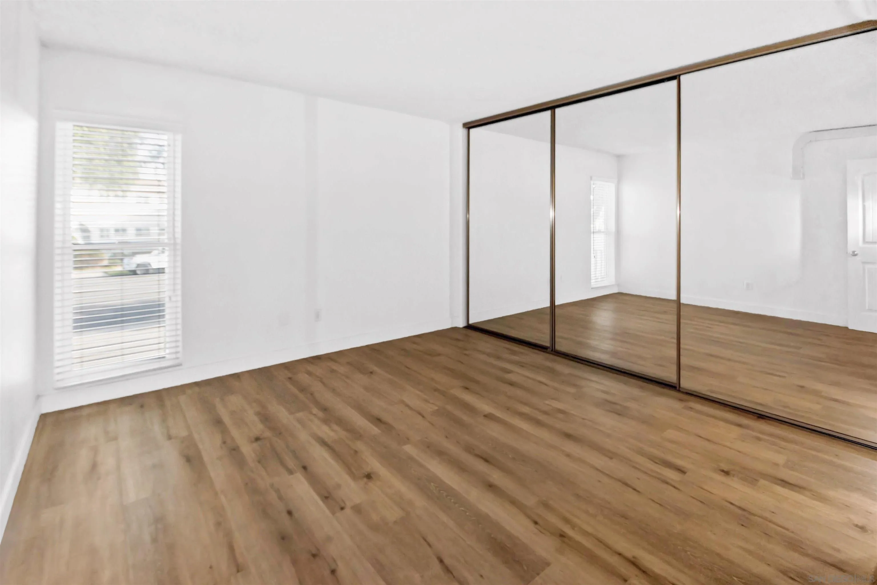 502 E Avenue Coronado, CA 92118 - Photo 14 of 18 a view of an empty room with wooden floor and a window