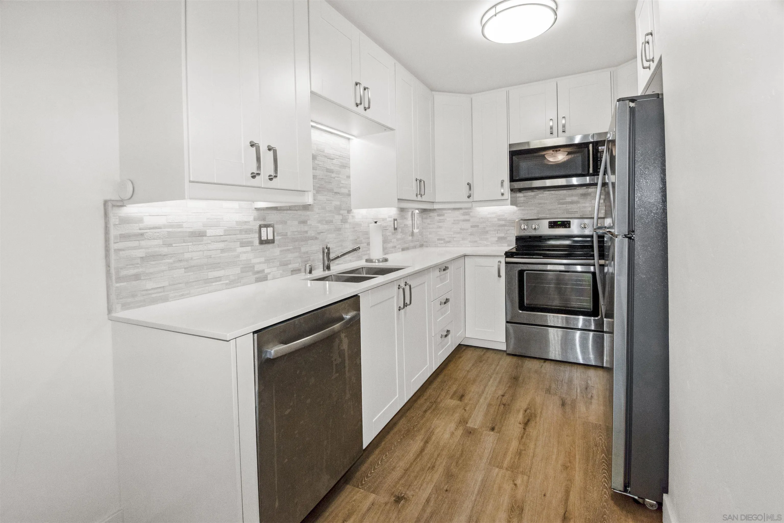 502 E Avenue Coronado, CA 92118 - Photo 6 of 18 a kitchen with stainless steel appliances a sink stove and refrigerator