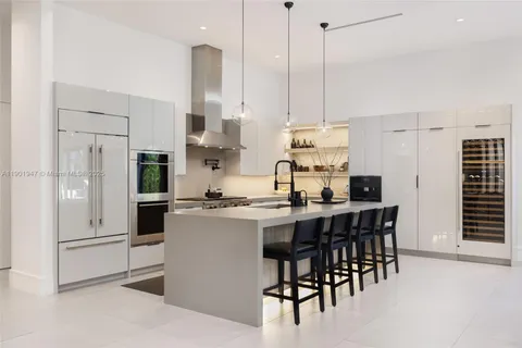 a kitchen with stainless steel appliances kitchen island granite countertop a sink and cabinets