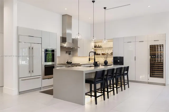 a kitchen with stainless steel appliances kitchen island granite countertop a sink and cabinets