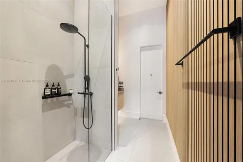 a large white kitchen with a large window