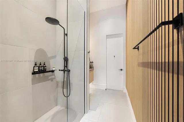 a large white kitchen with a large window