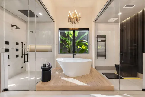 a large white kitchen with a large window