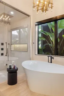 a kitchen with kitchen island granite countertop a sink and white cabinets