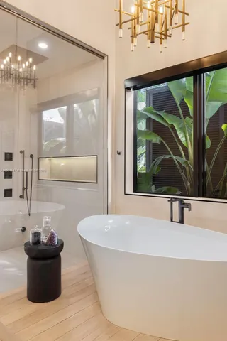 a kitchen with kitchen island granite countertop a sink and white cabinets