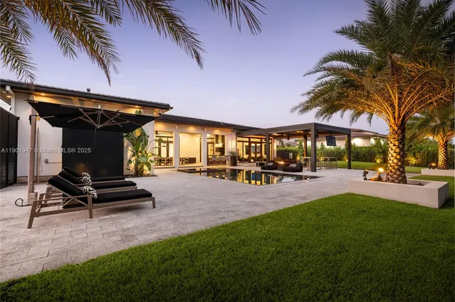 a view of a house with swimming pool and sitting area