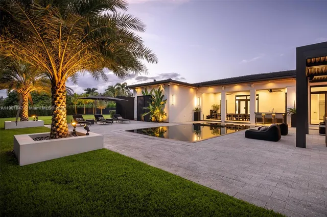 a view of a house with backyard porch and sitting area