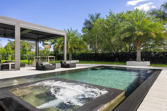 an aerial view of a house with swimming pool and patio