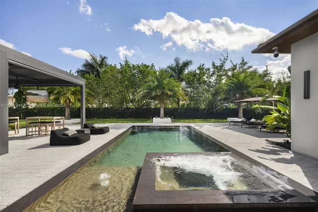 an aerial view of a house with a yard basket ball court and outdoor seating