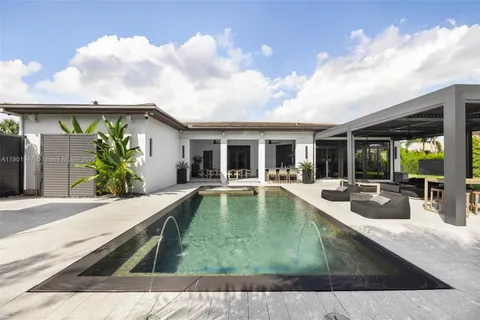 an aerial view of a house with a garden and swimming pool