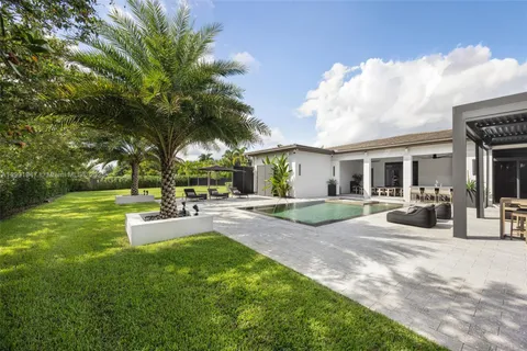 an aerial view of swimming pool having outdoor seating