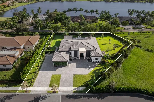 an aerial view of a house with a swimming pool