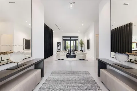 a living room with furniture and large windows