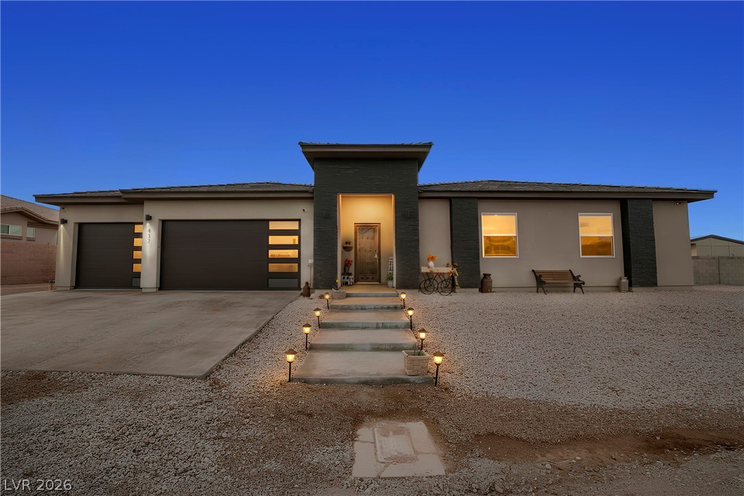 432 North Racetrack Road Henderson, NV 89015 - Photo 3 of 45 Prairie-style house with concrete driveway, a garage, and stucco siding