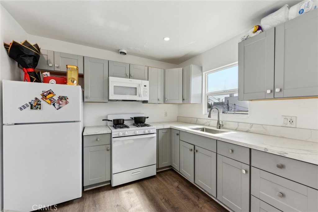 9320 Long Beach Boulevard South Gate, CA 90280 - Photo 13 of 30 a kitchen with a sink cabinets and wooden floor