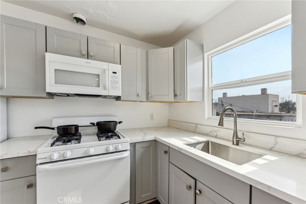 9320 Long Beach Boulevard South Gate, CA 90280 - Photo 14 of 30 a kitchen with a sink stove and microwave