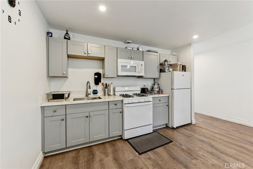 9320 Long Beach Boulevard South Gate, CA 90280 - Photo 15 of 30 a kitchen with sink cabinets and wooden floor