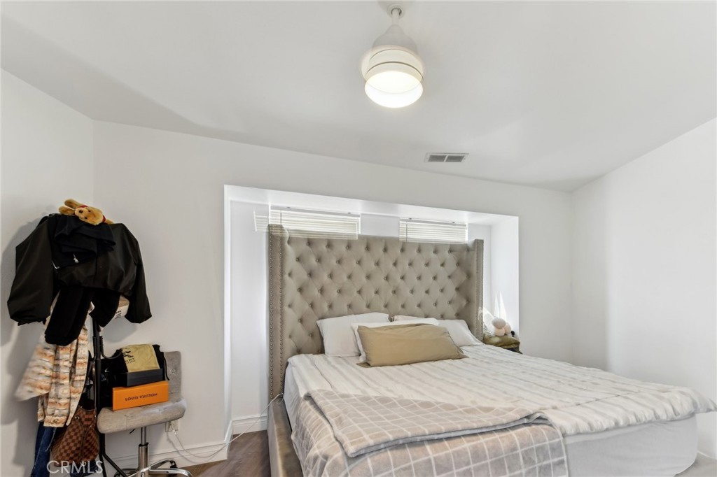 9320 Long Beach Boulevard South Gate, CA 90280 - Photo 18 of 30 a bedroom with a bed and a chandelier