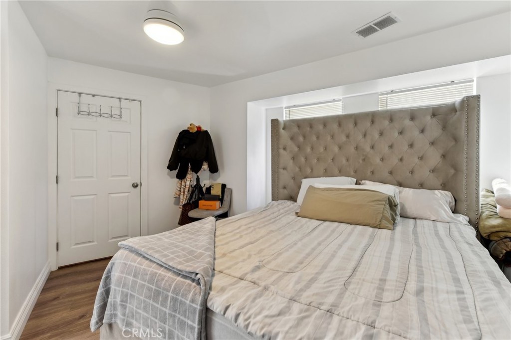 9320 Long Beach Boulevard South Gate, CA 90280 - Photo 20 of 30 a bedroom with a bed and wooden floor