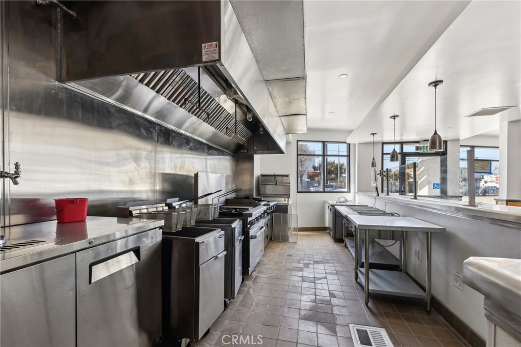9320 Long Beach Boulevard South Gate, CA 90280 - Photo 23 of 30 a kitchen with stainless steel appliances granite countertop a sink a stove and a wooden floors