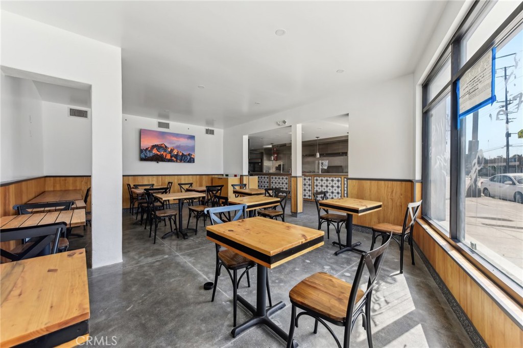 9320 Long Beach Boulevard South Gate, CA 90280 - Photo 28 of 30 a living room with furniture a flat screen tv and a table