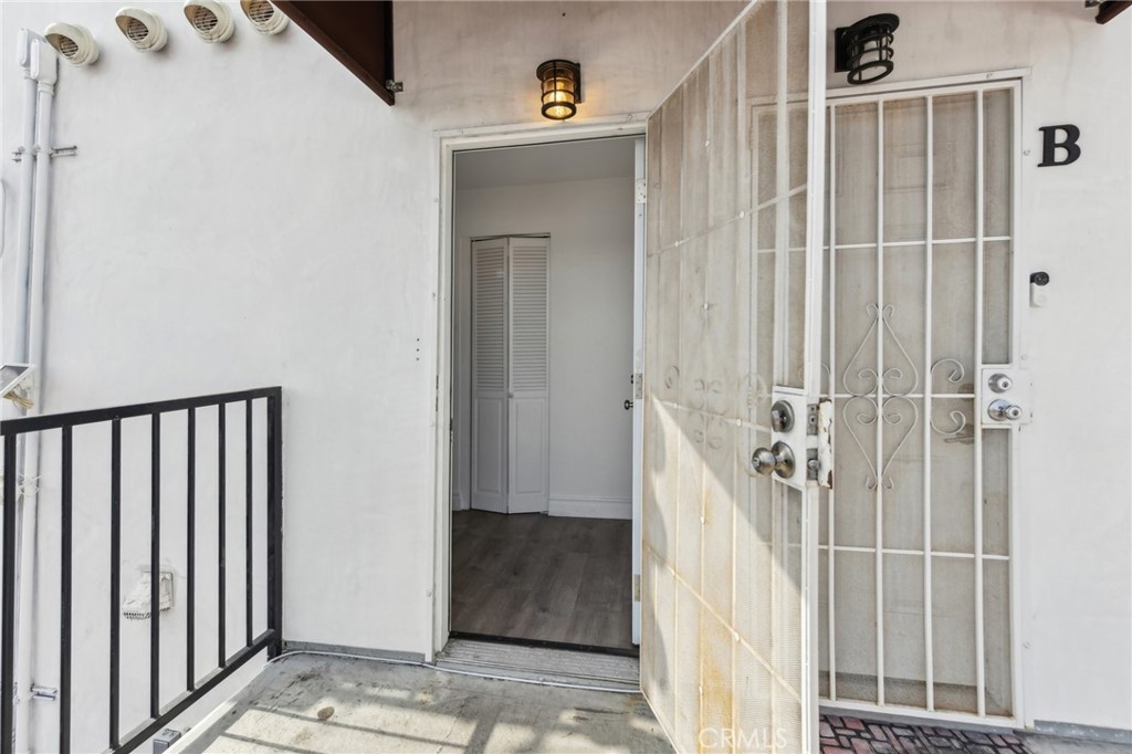 9320 Long Beach Boulevard South Gate, CA 90280 - Photo 4 of 30 a view of a hallway with a door and stairs