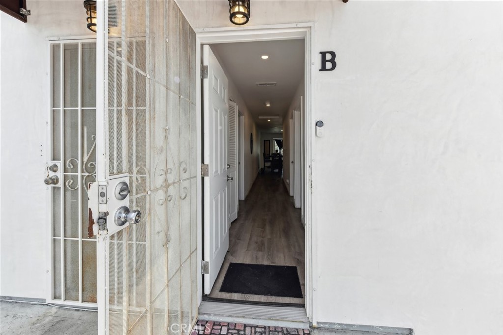 9320 Long Beach Boulevard South Gate, CA 90280 - Photo 5 of 30 a view of a hallway with wooden floor and staircase