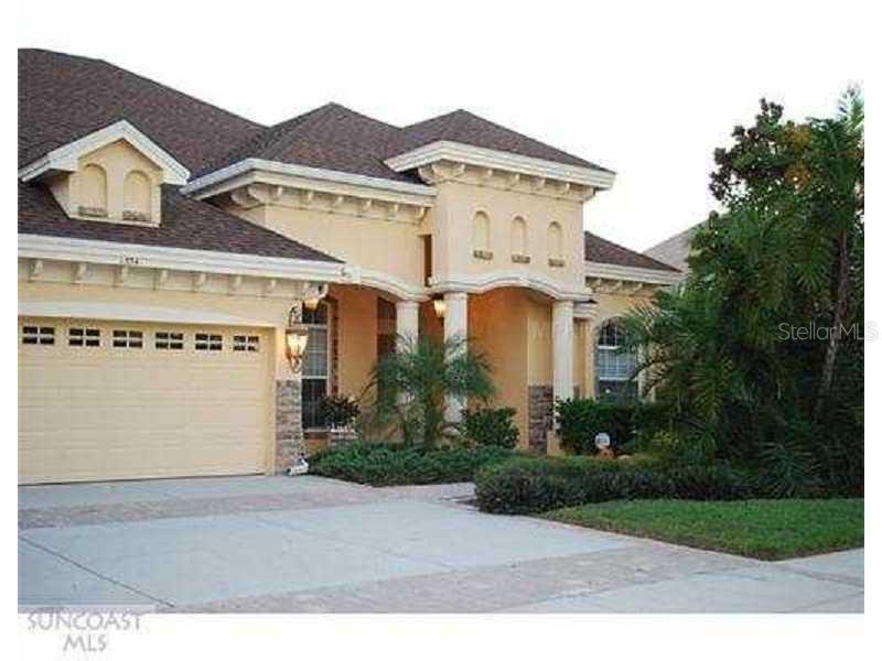 1554 Parilla Circle Trinity, FL 34655 - Photo 1 of 1 a view of a white building among the street with palm trees