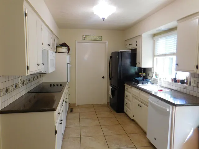 a kitchen with a sink stove and refrigerator