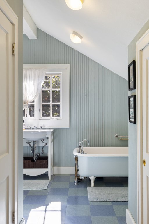 1609 Wethersfield Road Austin, TX 78703 - Photo 19 of 38 Bathroom featuring vaulted ceiling, tile patterned floors, and a freestanding bath