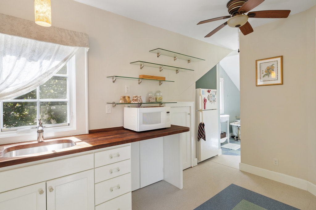 1609 Wethersfield Road Austin, TX 78703 - Photo 26 of 38 Kitchen featuring open shelves, butcher block counters, white appliances, white cabinetry, and ceiling fan