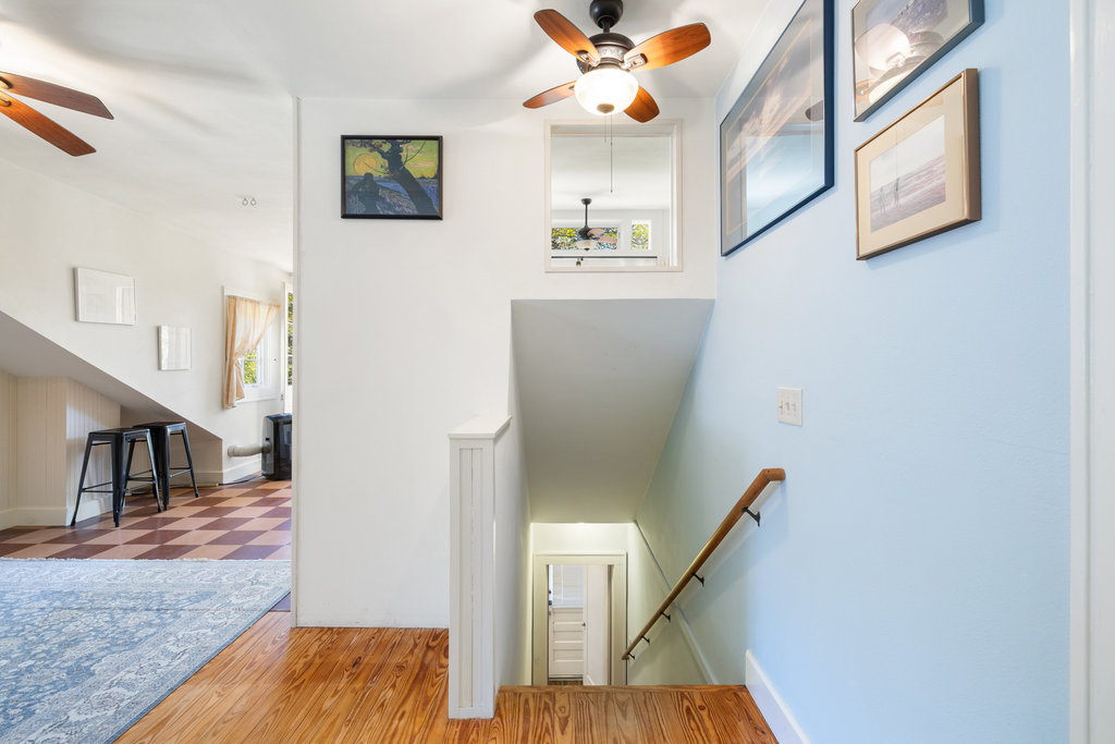 1609 Wethersfield Road Austin, TX 78703 - Photo 28 of 38 Staircase with healthy amount of natural light, ceiling fan, and wood finished floors