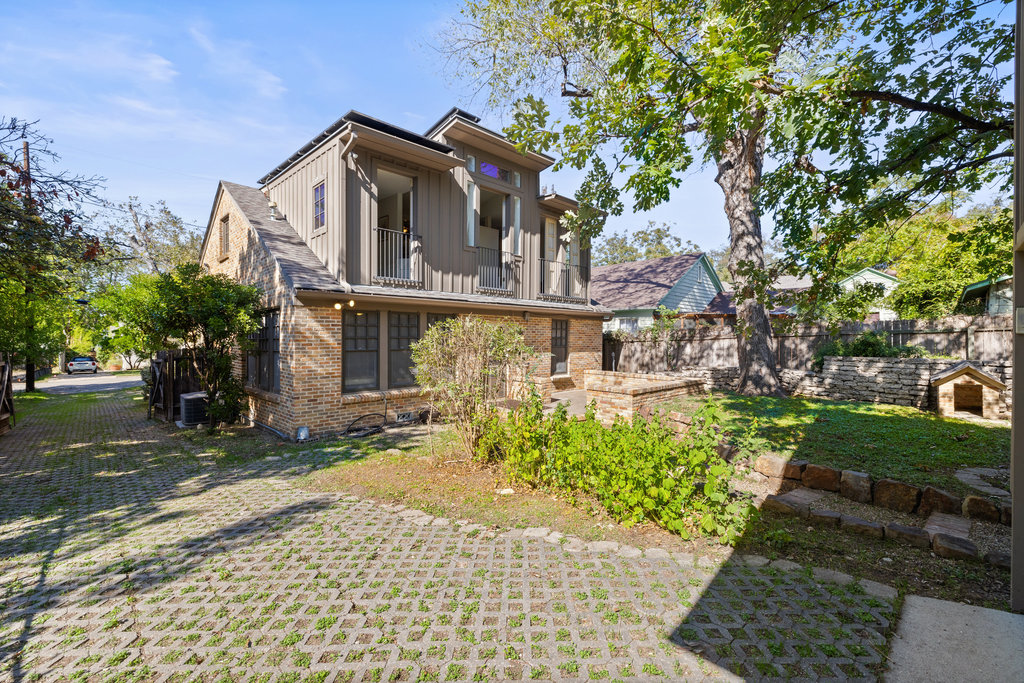 1609 Wethersfield Road Austin, TX 78703 - Photo 38 of 38 Back of property featuring board and batten siding, brick siding, and a balcony